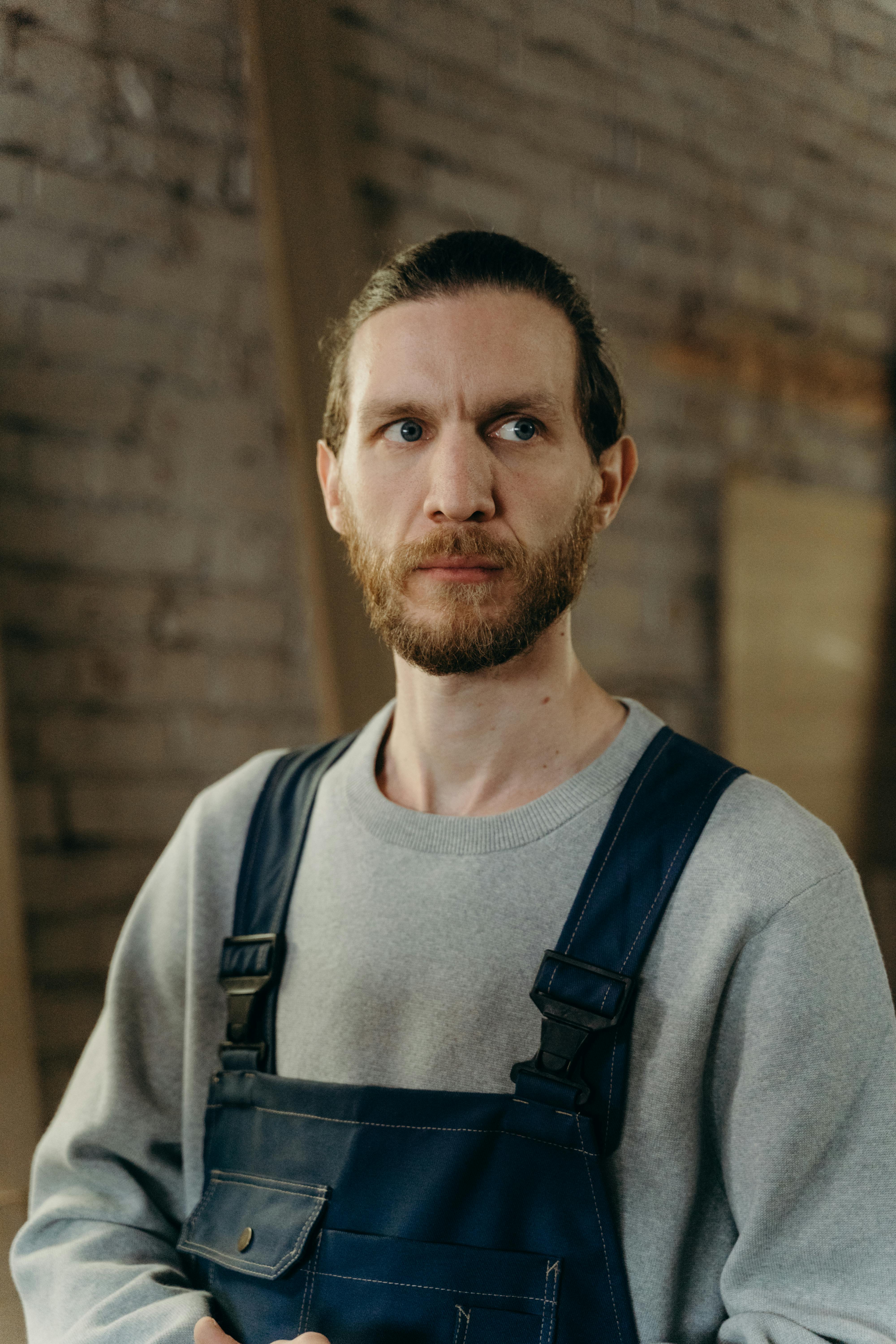 Professional plumber in work overalls ready for emergency service