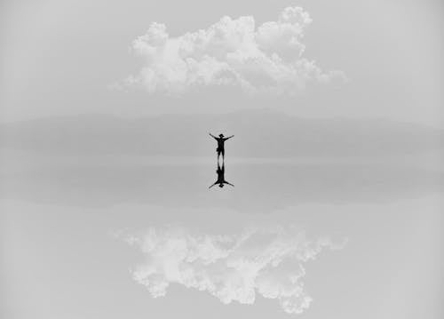 Free Person standing on a Shallow Body of Water  Stock Photo