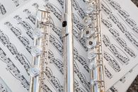 Silver Flutes on a Music Sheet