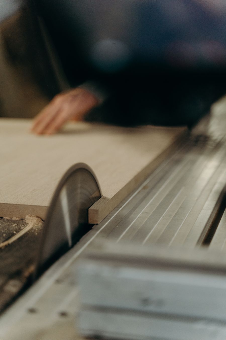 Carpenter cutting timber panel in a workshop