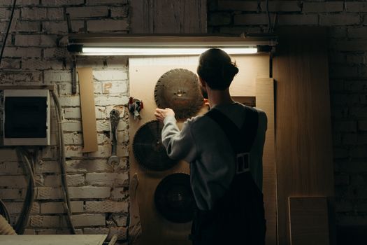 A Man Looking a Circular Saw Blade