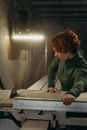 Woman in Green Jacket Sitting on Chair