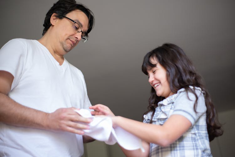 A Man Wiping Her Daughter's Hands