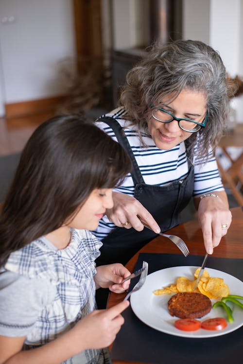 A Woman Teaching Her Daughter a Proper Etiquette