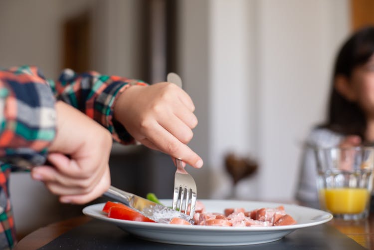 A Person Holding Fork And Knife