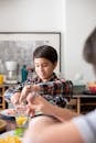 Boy in Red Blue and White Plaid Button Up Shirt Holding a Spoon