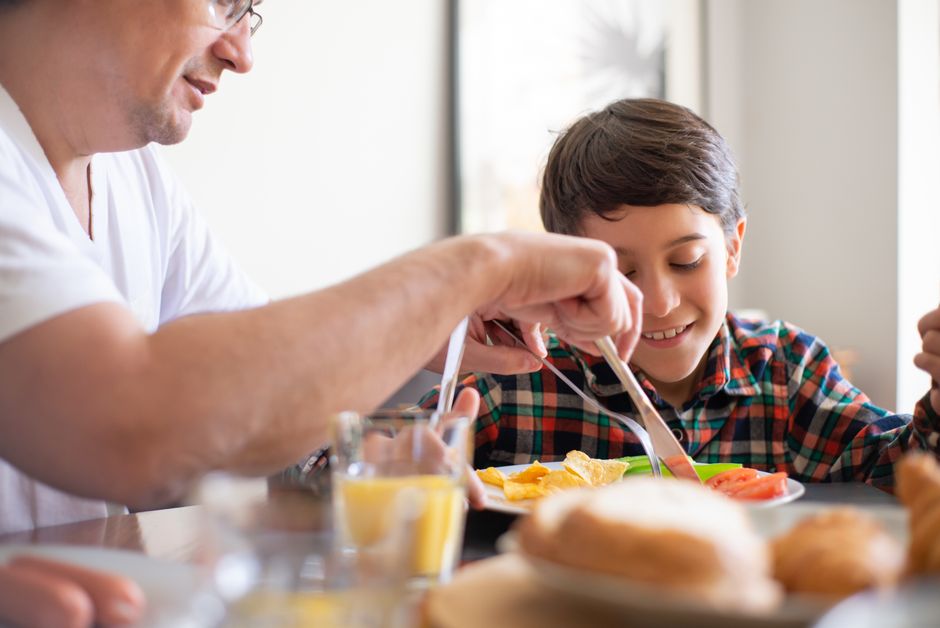 Photo by Kampus Production on Pexels A heartwarming scene of a father teaching his son table manners during breakfast. - Photo by Kampus Production on Pexels