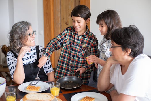 Family of four enjoying a lively breakfast at home with waffles and orange juice.