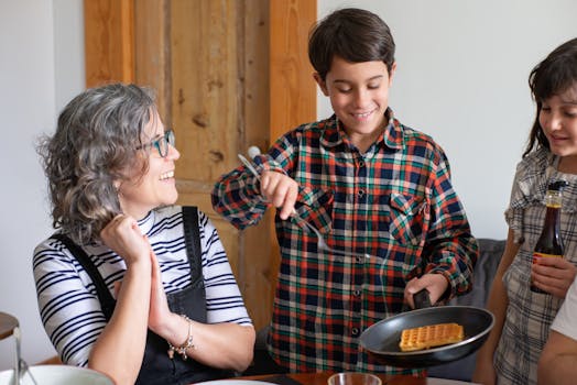 A cheerful family moment as a boy serves waffles at the breakfast table.