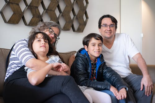 Free Photo of a Family Sitting on a Sofa Together Stock Photo
