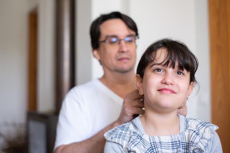 Photograph Of A Father Fixing His Daughter's Hair