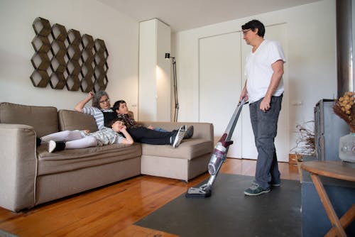 Free A Man Using a Vacuum Cleaner Stock Photo