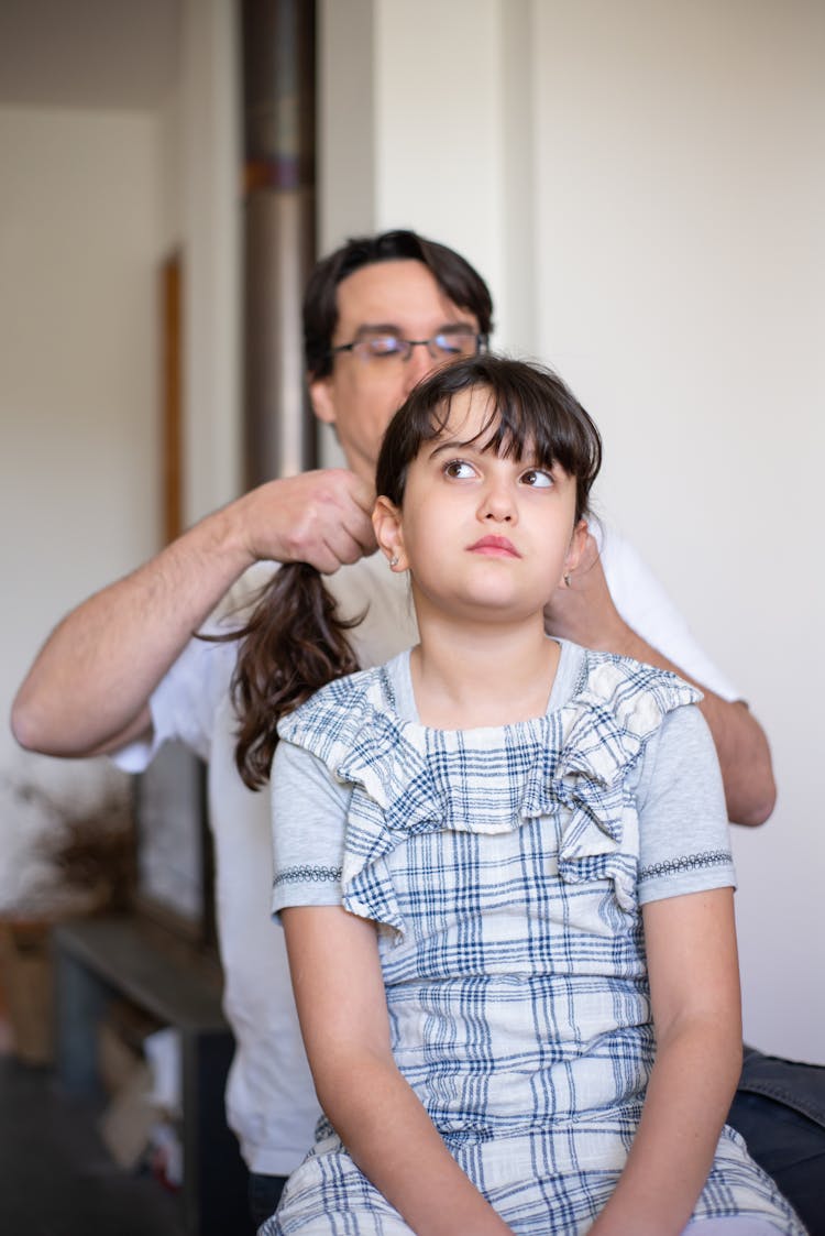 Man Fixing The Hair Of A Girl