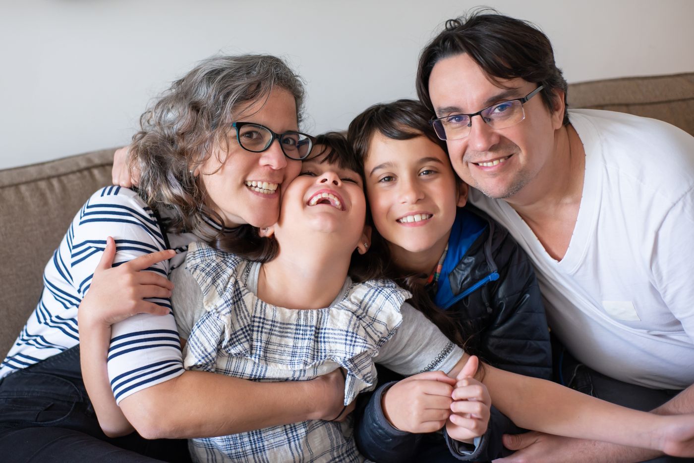 Family together on a sofa. Illustrative stock photograph.