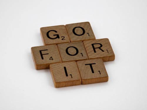 Close-Up Shot of Wooden Blocks on White Surface