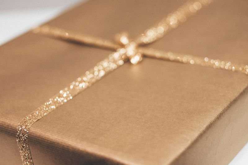Luxurious gold gift box with glittering ribbon