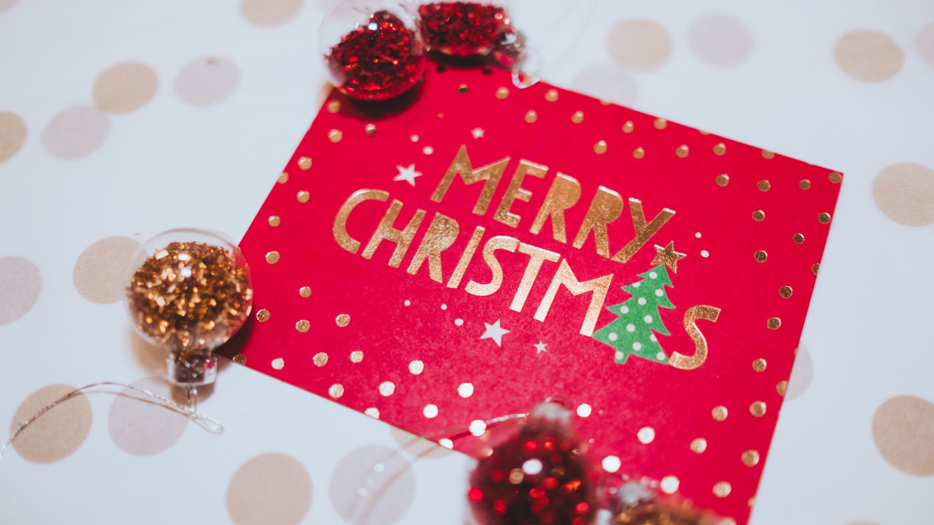 Greeting Cards: Explore the Art of Connection 5 A vibrant red Merry Christmas card surrounded by festive glitter ornaments, perfect for holiday celebrations — greeting cards