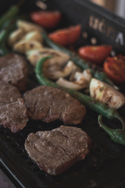 Free Succulent grilled steak with assorted vegetables on a barbecue grill, perfect for summer gatherings. Stock Photo