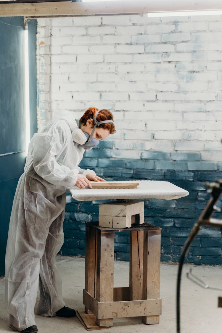 Woman In White Robe Sitting On Brown Wooden Chair