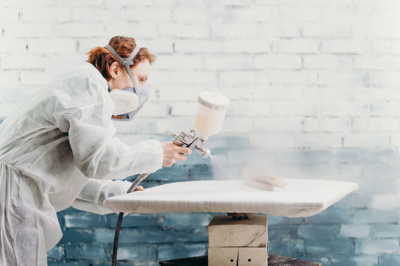 A cabinet door being sprayed