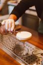 Person Pouring Milk on Clear Footed Glass