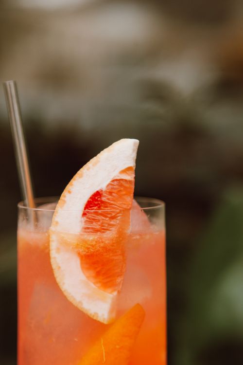 Free Close-up of a grapefruit cocktail in a glass with ice cubes, perfect for summer refreshment. Stock Photo