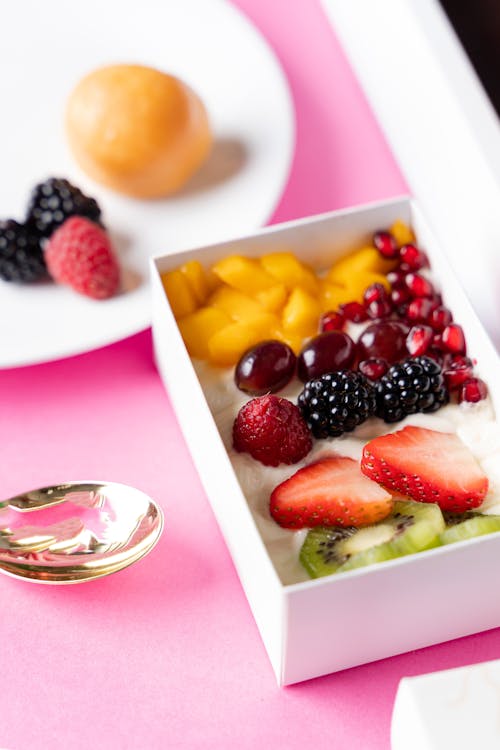 Free Photo of Fruits in a White Box Near a Ring Stock Photo