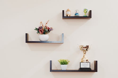 Brown Wooden Floating Shelves Mounted on Beige Painted Wall