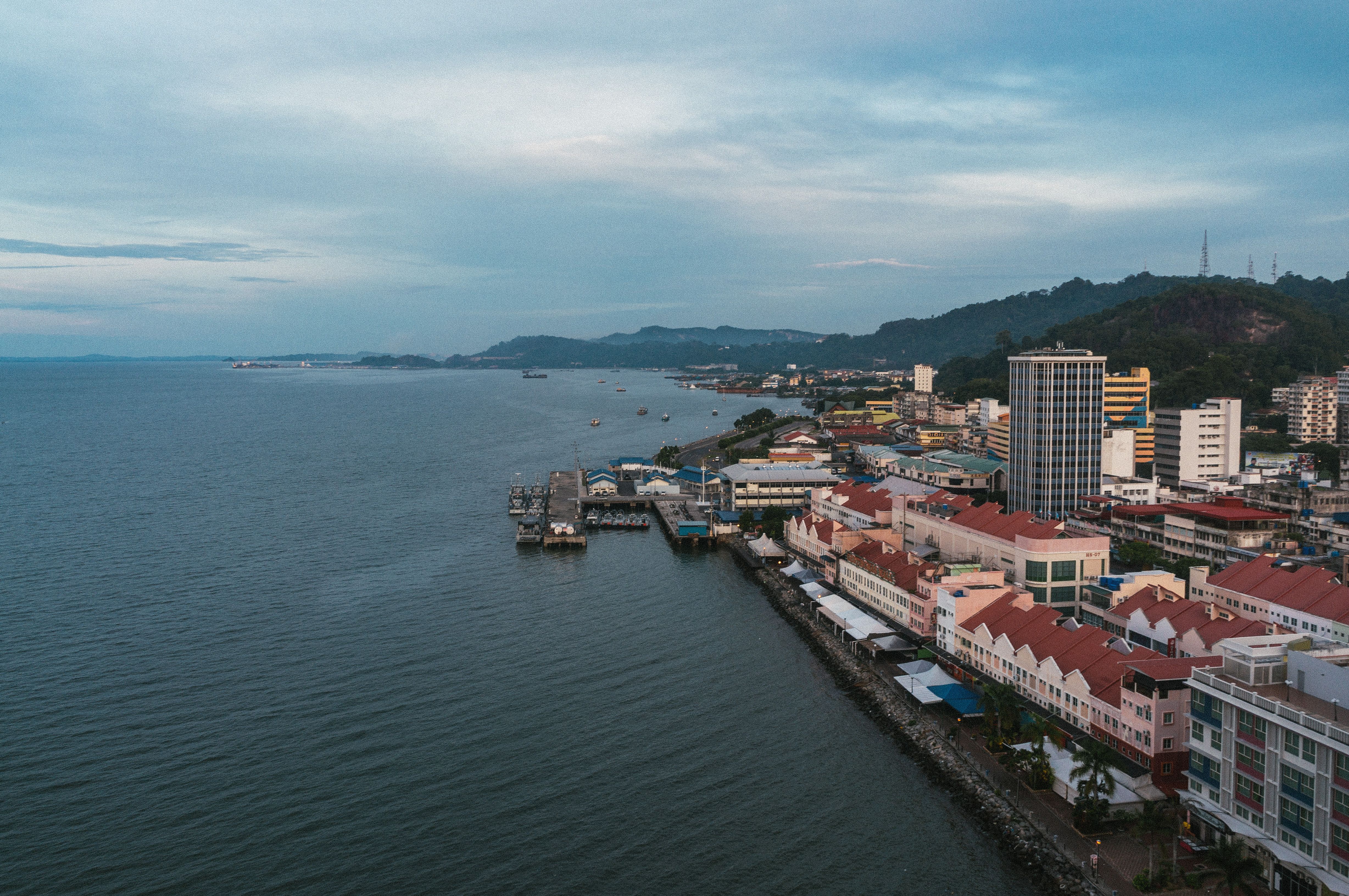 A scenic aerial view of a coastal city with waterfront architecture in Malaysia.