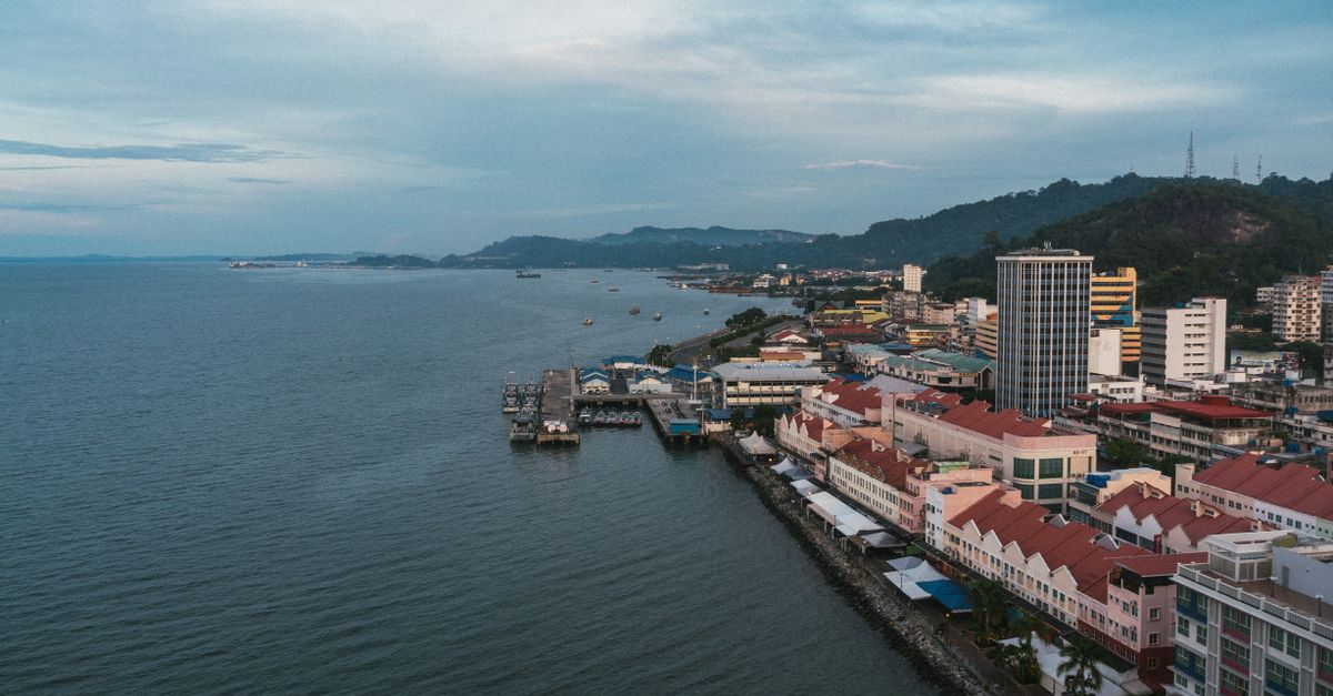 A scenic aerial view of a coastal city with waterfront architecture in Malaysia.