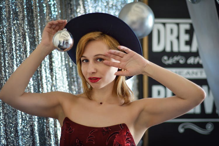 Stylish Woman In Hat Near Christmas Bubble