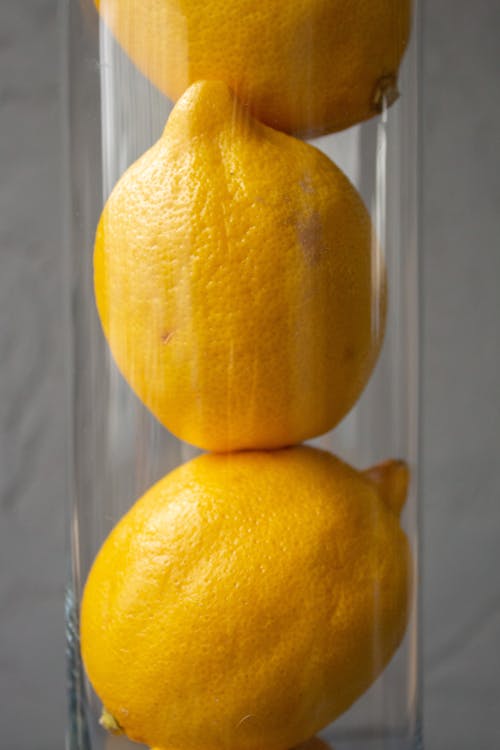 Free Healthy bright lemons stacked in glass vase Stock Photo