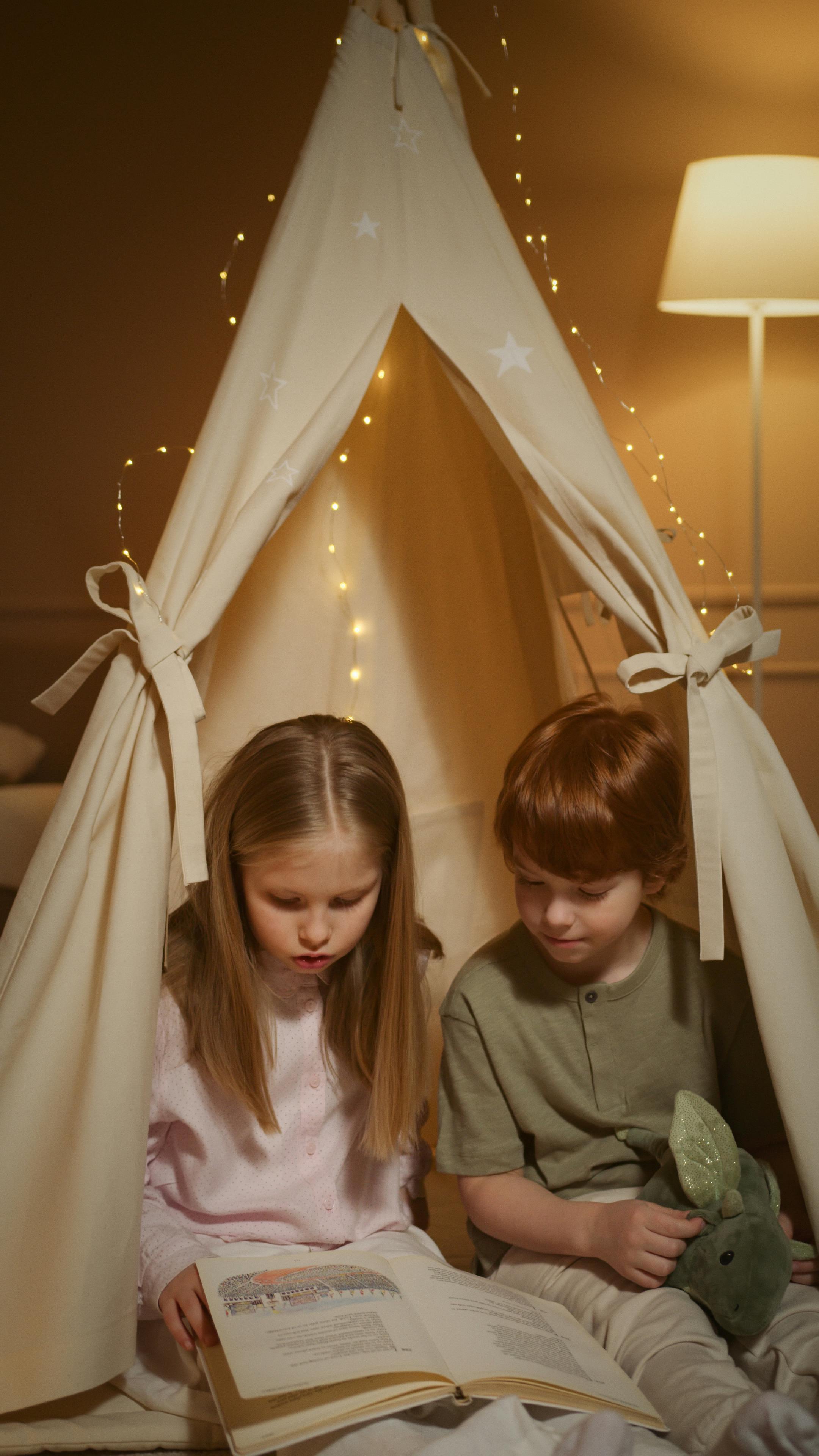 a boy and a girl reading a book