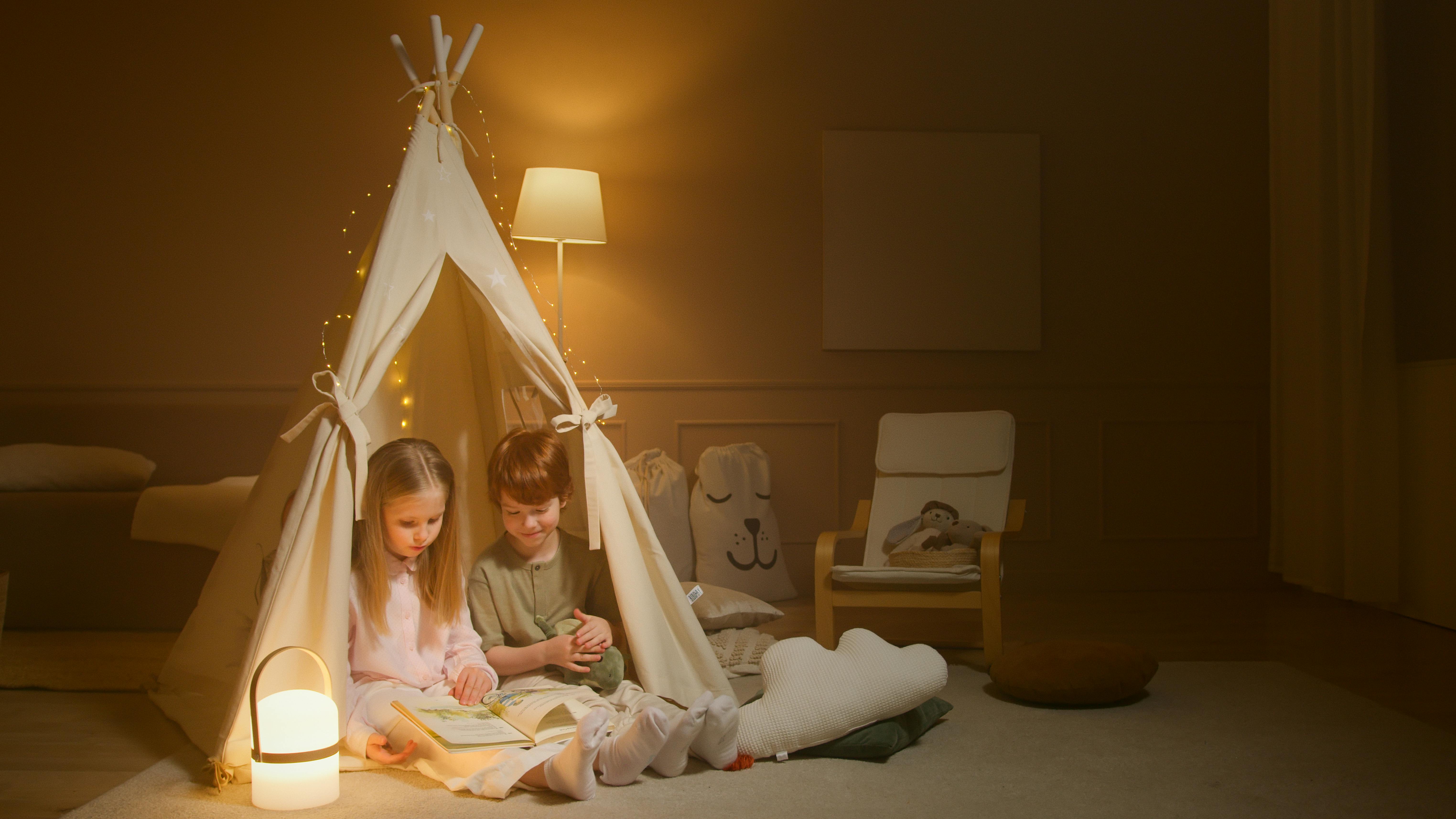 Children Reading a Book while inside an Indoor Tent · Free Stock Photo