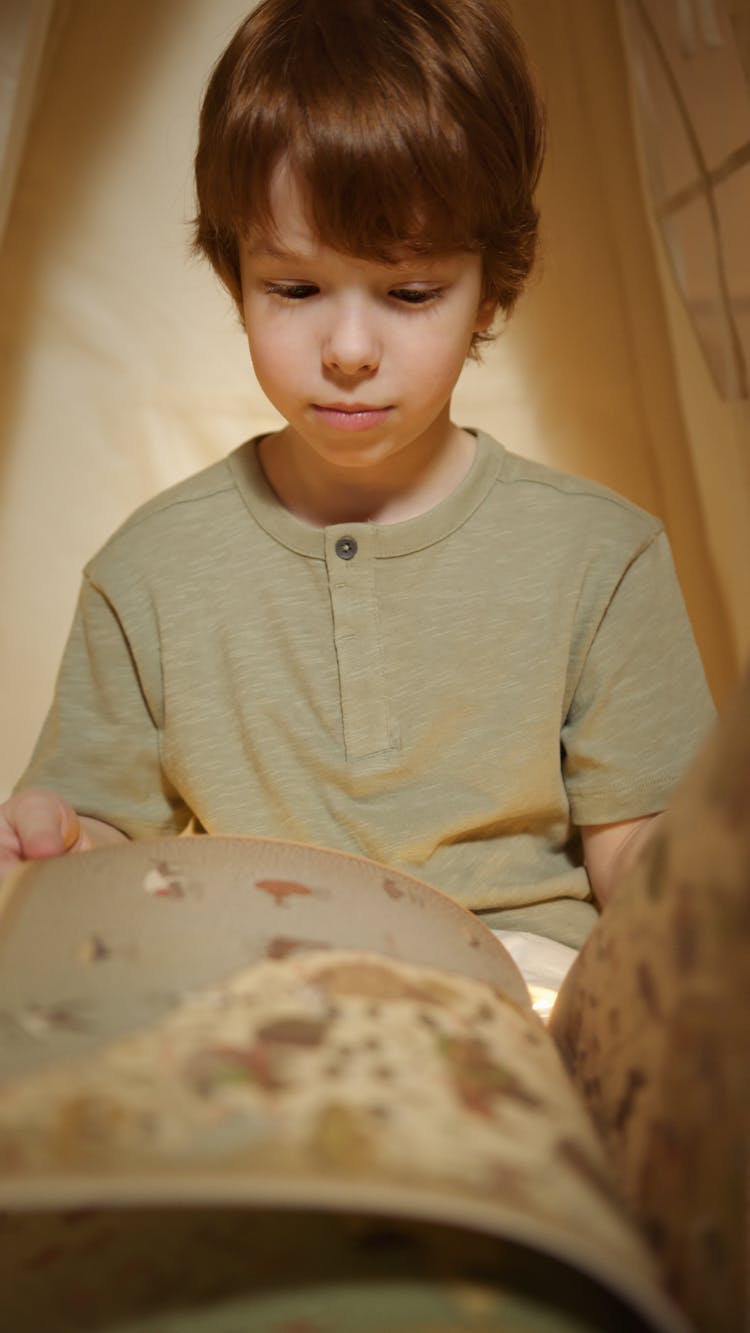 Photograph Of A Boy Looking At A Map