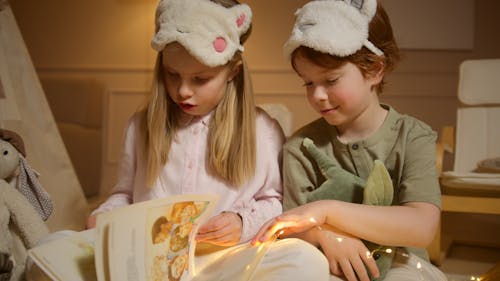 Free Photograph of Siblings Reading a Book Stock Photo