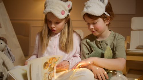 Photograph of Siblings Reading a Book