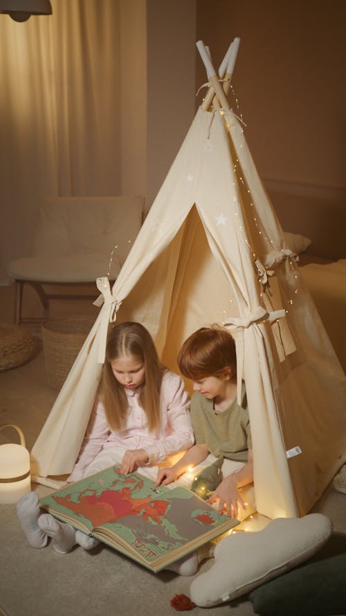 Free Photograph of Siblings Looking at a Map Stock Photo