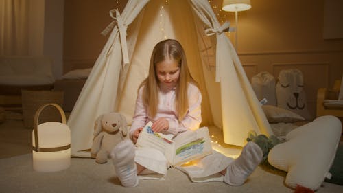 Free Photograph of a Girl in a Pink Shirt Reading a Book Stock Photo