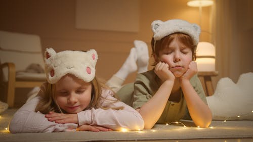 Free Photograph of Siblings with Sleep Masks Stock Photo