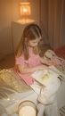 Girl in Pink Shirt Sitting on Bed