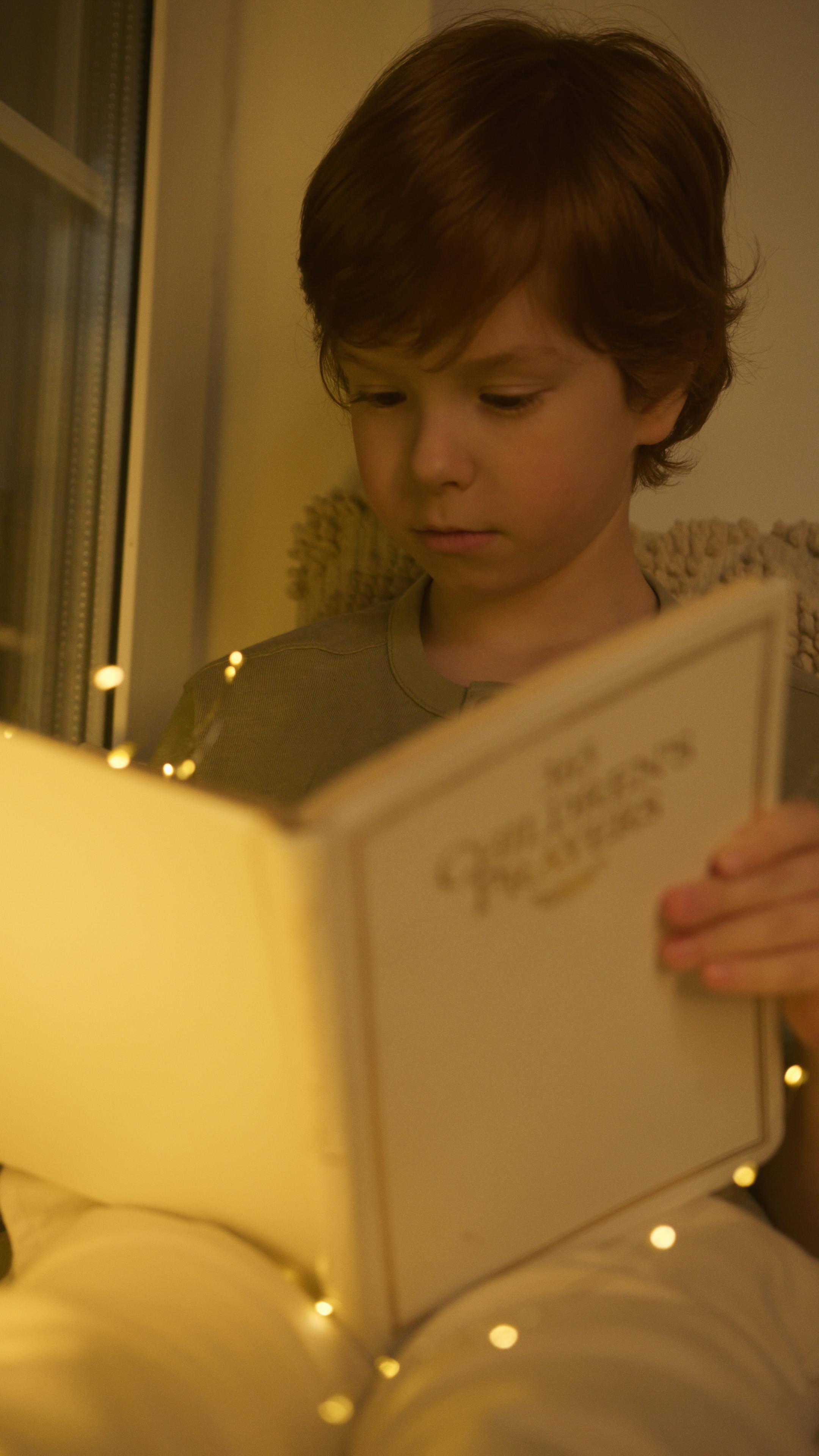 photo of a boy with red hair reading a book