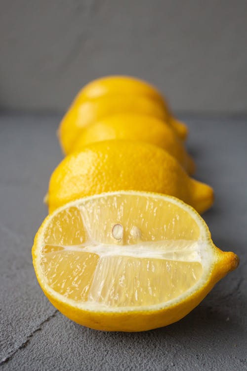 Free Juicy raw lemons placed on gray table Stock Photo