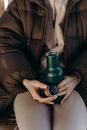 Person Holding Green Vacuum Flask