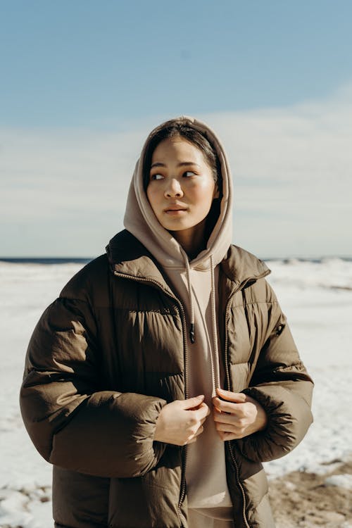 A Woman in Hoodie Sweater and Puffer Jacket