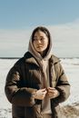 Woman in Black Leather Jacket Standing on Snow Covered Ground