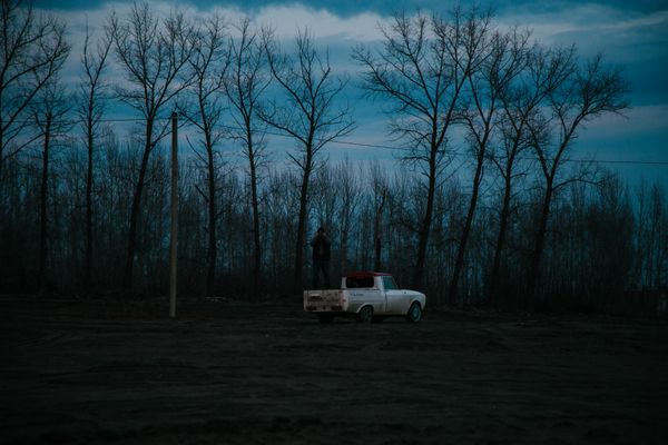 White pickup truck on a dirt road at twilight — photo by Natalia Kretinina on Pexels