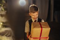 Boy in Brown Button Up Shirt Holding Orange Paper Bag