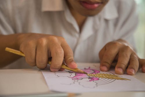 Boy Coloring With Pencil