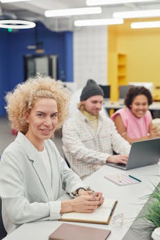 A diverse group of colleagues working together in a colorful, contemporary office environment.